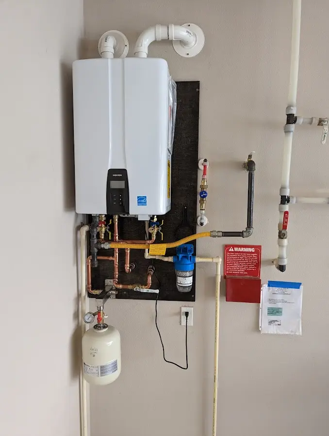 Professional plumber installing copper piping in a Osage Beach home